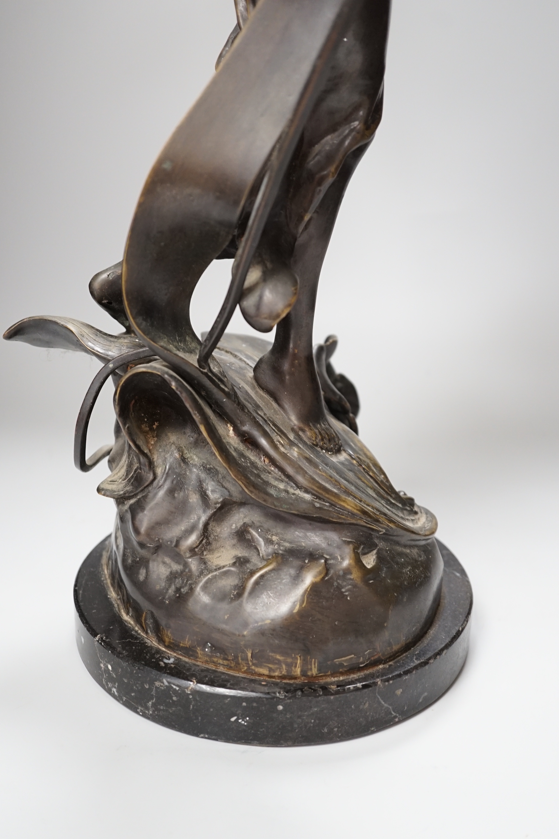 An Art Nouveau style fairy on a black marble base, 63.5cm high